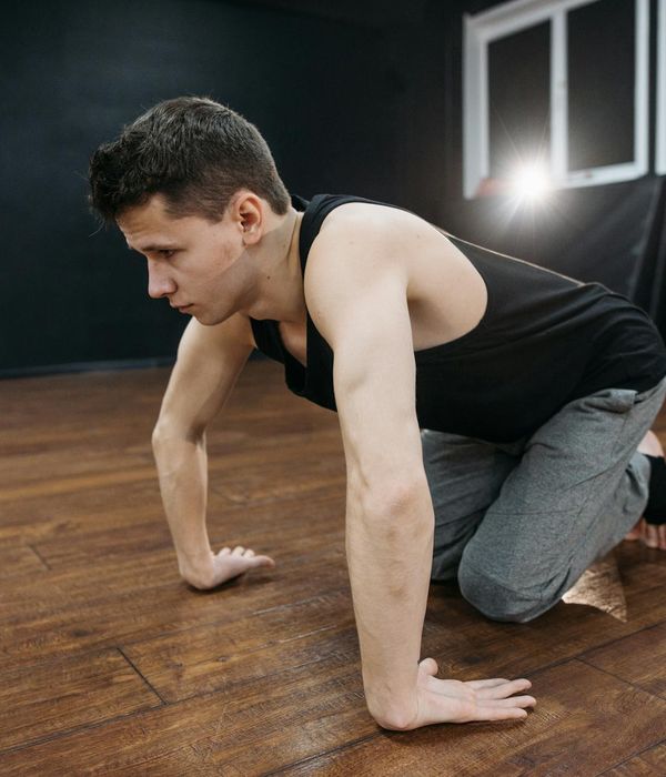 Man practicing controlled physical movements in dark atmosphere